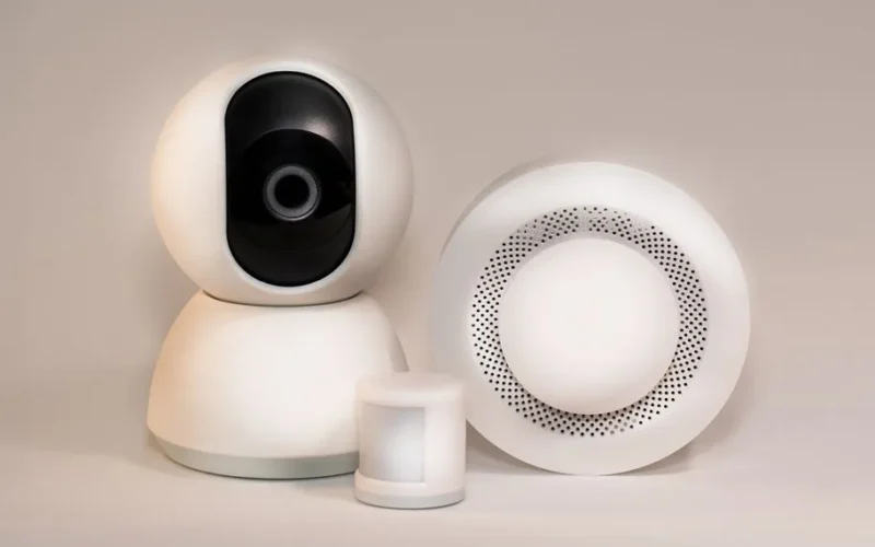 A collection of modern smart home security devices featuring cameras and sensors.
