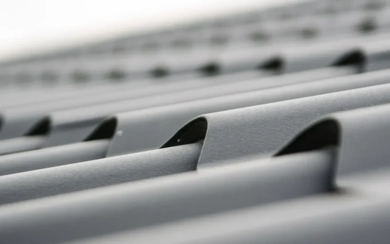 Detailed close-up of grey metal roof sheets showcasing texture and design.