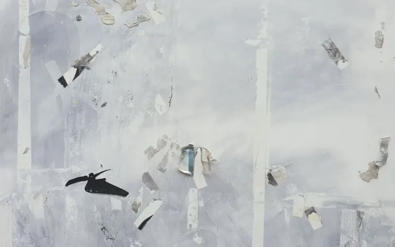 Minimalist abstract grunge wall with peeling textures and tape remnants.