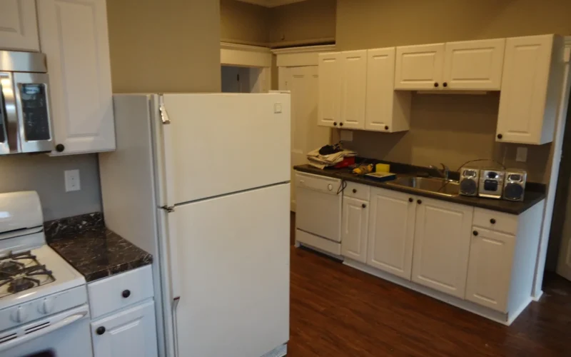 Kitchen renovation project with some tools and boombox still on counter.