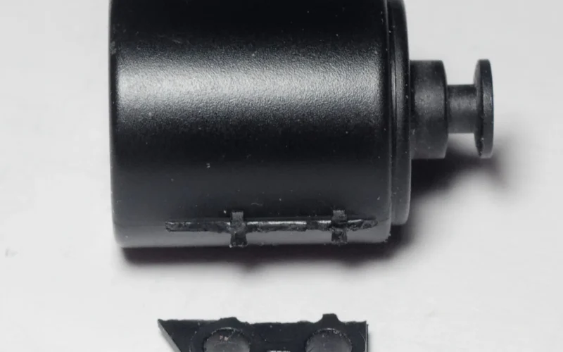 Revox B215 - tape transport - broken dashpot. This is a lightweight plastic thingie, made up of just two parts. Outer diameter of the larger can is around 18.5 mm. It seems that the tiny mounting handle has cracked well before, and was then waiting for one minuscule coup-de-grace to go down. Fixed with cellphone glue and, for now, seems to hold well.