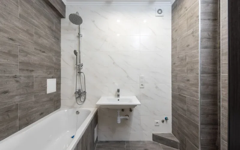 Elegant modern bathroom interior with wooden details and sleek design.