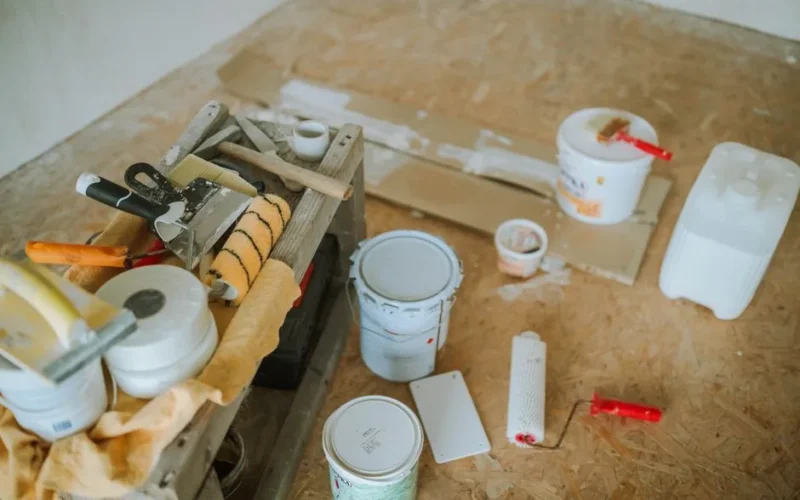 Overhead shot of tools and paint supplies for a home renovation project.
