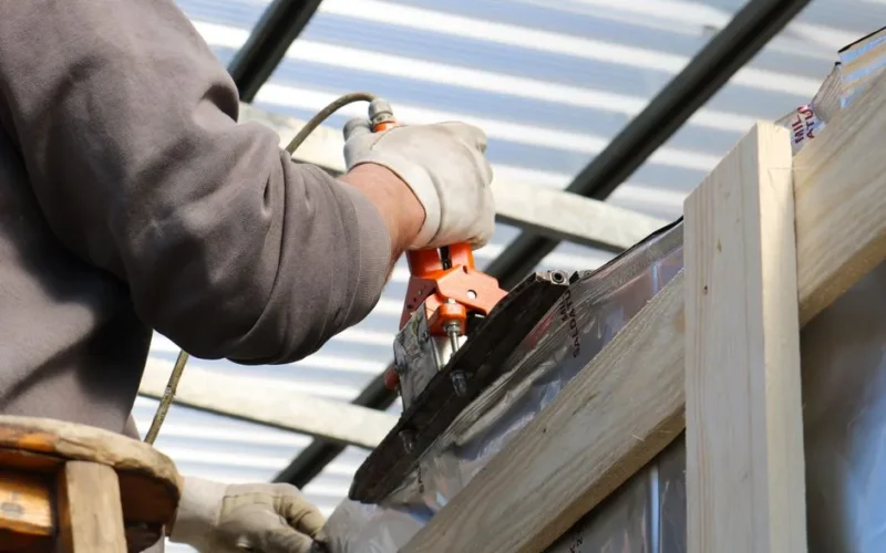 A construction worker using a power tool on a building project in Treviso, Italy.