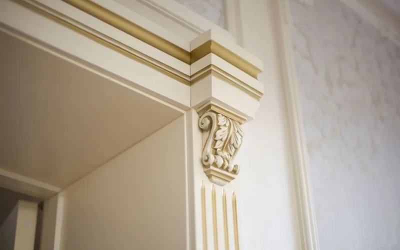 Elegant close-up of ornamental molding in a classic interior design setting.