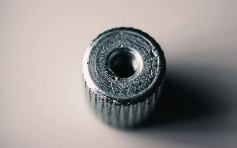 Detailed macro shot of a metal screw showing its textured surface and machining marks.