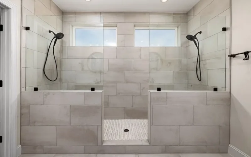 A sleek, contemporary dual shower bathroom featuring elegant tile work and modern fixtures.