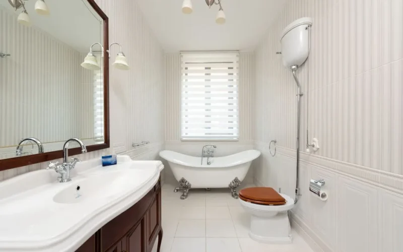 Spacious bathroom featuring a classic clawfoot tub, vanity, and wooden toilet seat.